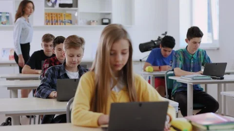 Interesting computer science class in modern school. View of lovely girl and her Video stock 111548174