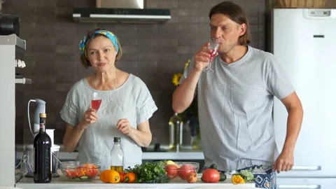 An interesting couple with a difference in age. Man and woman in the kitchen. A Stock Footage 96490318