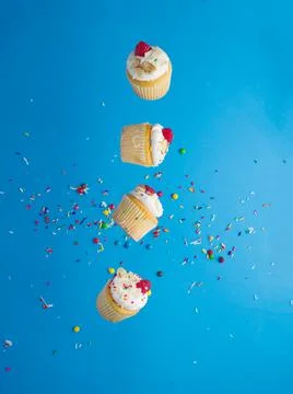 Interesting creative composition. Small holiday muffins with fresh raspberrie Stock Photos