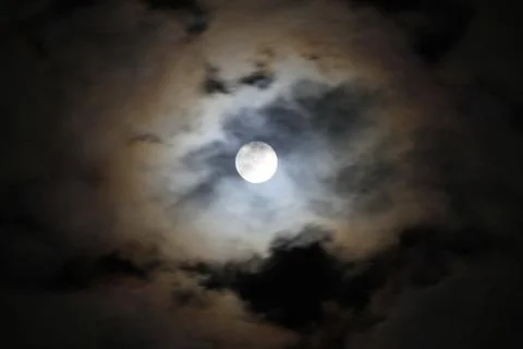 Interesting full moon in a cloudy night Stock Photos