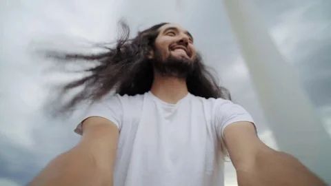 Interesting man with long hair spins around Stock Footage