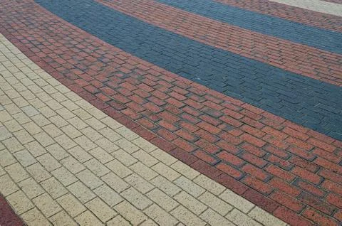 Interesting pattern of red black and beige bricks 스톡 사진