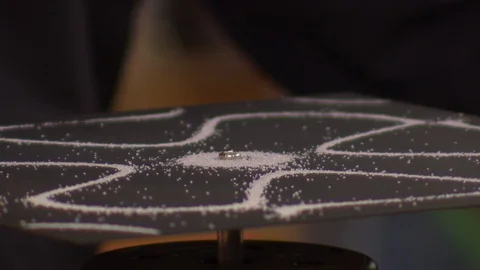 Interesting patterns created due to sands reaction to audio waves Stock Footage 99055351