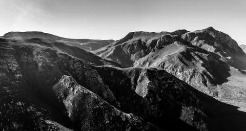 Interesting patterns of sandstone mountains with eerie shadows during sunset Foto stock