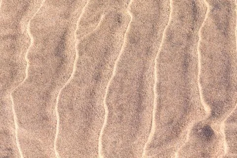 Interesting ripples in beach sand that create interesting abstract texture. Stock Photos