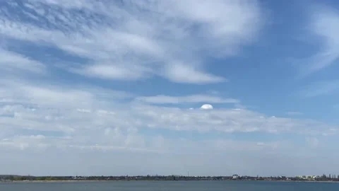Interesting small white cloud in the form of a white cap  visible in the clouds. Stock Footage 237029543