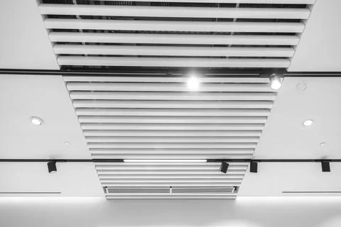 Interesting white lath ceiling with modular light fixtures Stock-Fotos