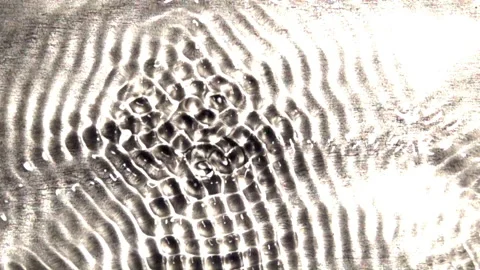 Interference patterns in a wave tank oscillate between states of Stock Footage 144631050