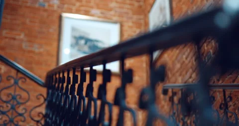 An interfloor span and a staircase with forged railing in a new brick building  Stock Footage 119562883