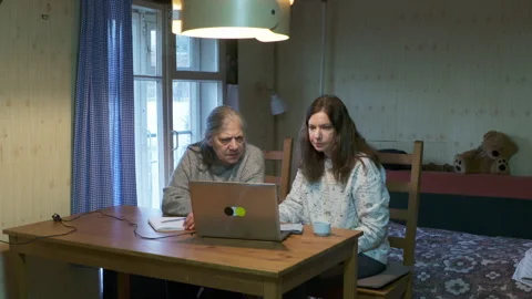 Intergenerational Computer Use: Daughter and Mother Learning on Laptop Indoors Stock Footage 321147913
