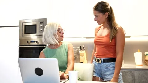 Intergenerational knowledge sharing in a modern kitchen setting Stock Footage 316556297