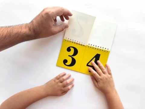 Intergenerational learning with a calendar featuring bold numbers Stock Photos