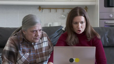Intergenerational Learning: Daughter Guides Mother Through Online Shopping Stock Footage 304294563