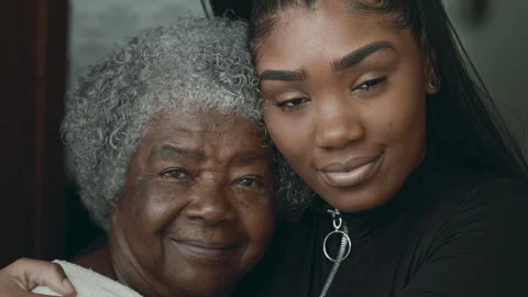 Intergenerational love and affection - Young black latina granddaughter put.. Stock Footage 264776564
