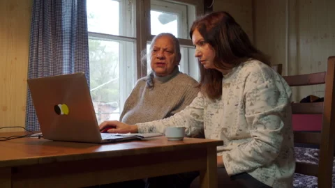 Intergenerational Support: Daughter Teaches Elderly Mother How to Use a Computer Stock Footage 320326063