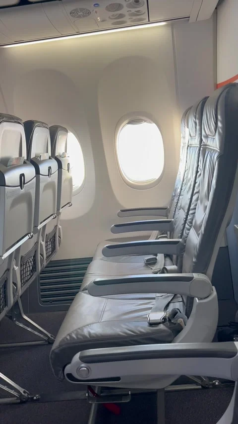 Interior of airplane with empty seats and scenery from the plane window Stock Footage 336912818
