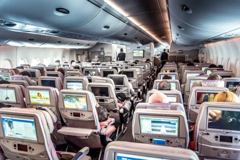 Interior of airplane with passengers Stock Photos