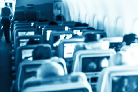Interior of airplane with passengers Stock Photos