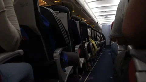 Interior of airplane with passengers on seat during flight. Chairs on aisle Stock Footage 89923632