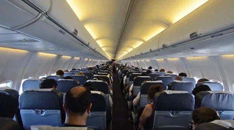 Interior of airplane with passengers on seats Stock Footage 36015638