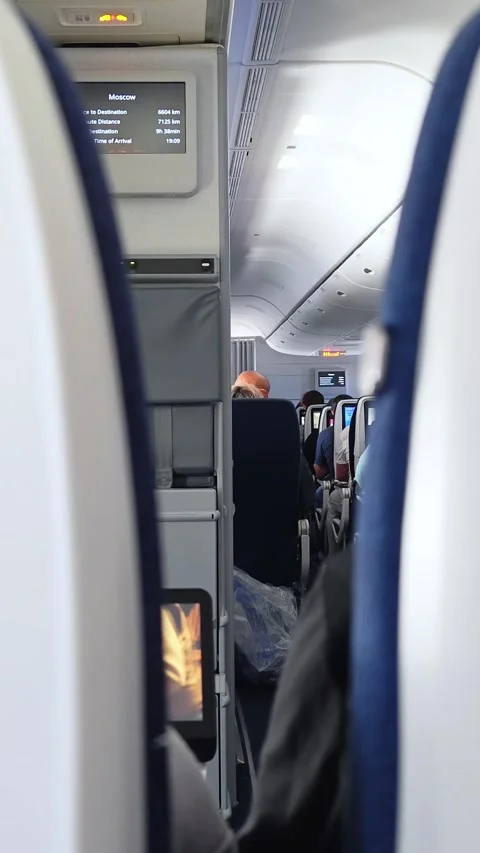 Interior of airplane with passengers on seats. View inside in plane. Turbulence. Stock Footage 307425636