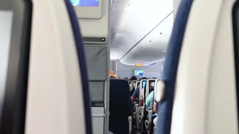 Interior of airplane with passengers on seats. View inside in plane. Turbulence. Stock Footage 307841172