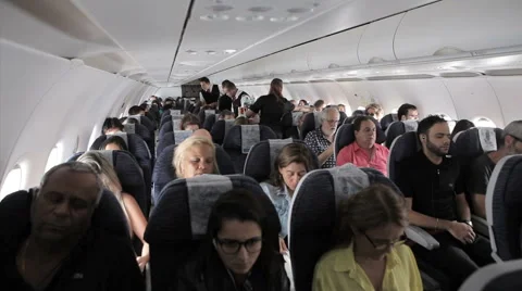 Interior airplane, point of view as passenger from coach seats as travelers Stock Footage