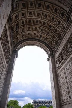 Interior arch of Arc de Triomphe in Paris with cloudy sky Stock Photos