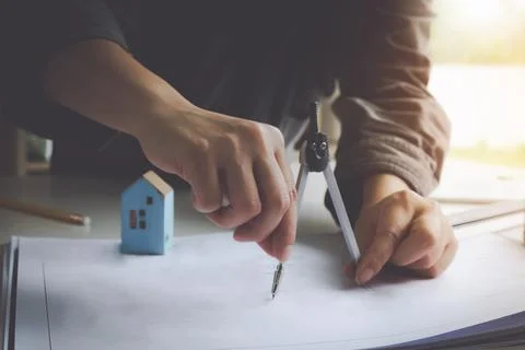 Interior Architect with blueprint for architectural plan, engineer sketching a Stock Photos