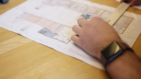 Interior architect is controlling his building plan Stockbeeldmateriaal 119782290