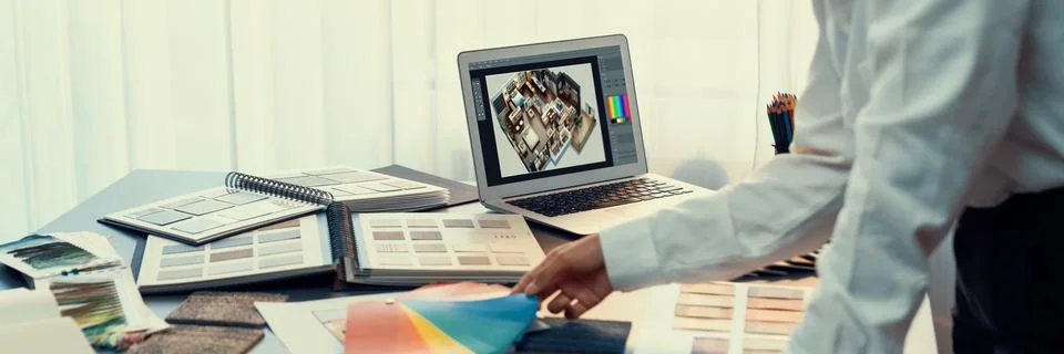 Interior architect designer at table choosing color selection. Insight Stock Photos
