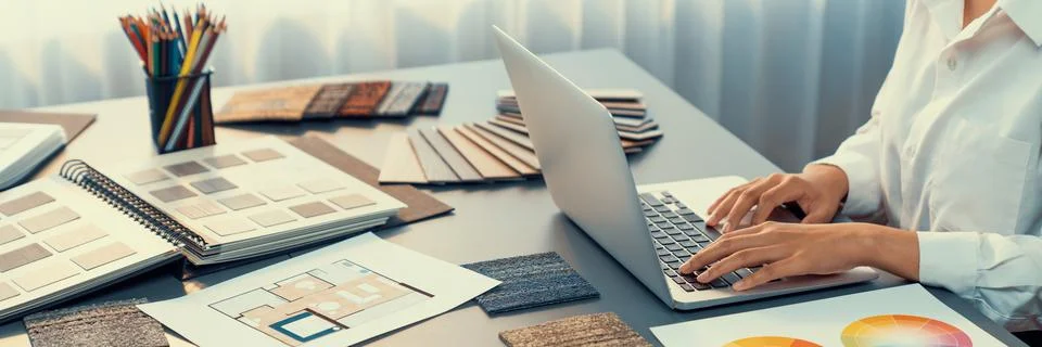 Interior architect designer at table designing house interior. Insight Stock Photos