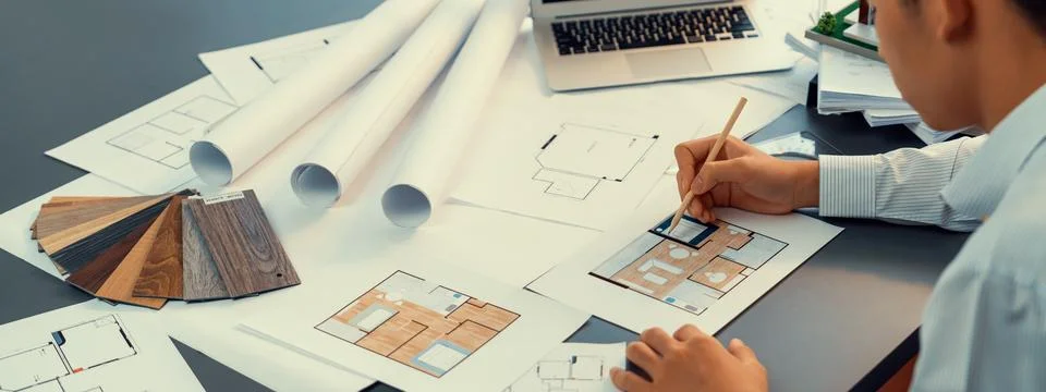 Interior architect designer at table designing house interior. Insight Stock Photos