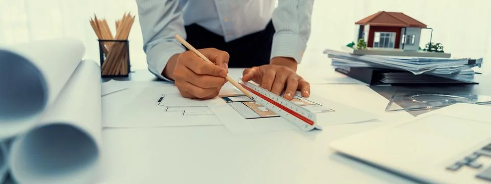 Interior architect designer at table designing house interior. Insight Stock Photos