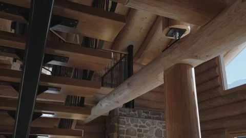 Interior architectural details of a rustic log cabin with exposed wooden beams Stock-Footage 335757382