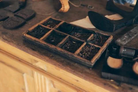 Interior with attributes of an old-fashioned shoemaker. Stock Photos