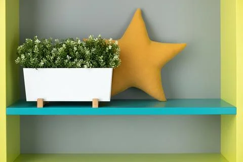 Interior background, copy space. Planter with plant, pillow in shape of orang Stock Photos