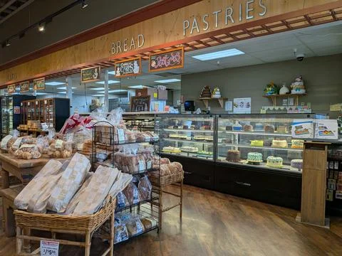 Interior bakery section featuring breads, pastries, cakes Stock-Fotos