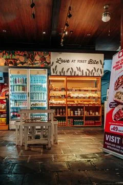 Interior of a bakery shop displaying packaged bread drinks and snacks on Foto stock