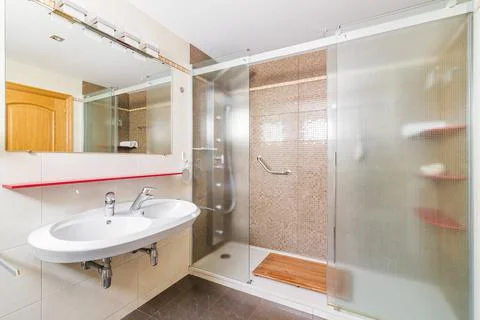 Interior of a bathroom in light tones with spacious shower Stock Photos