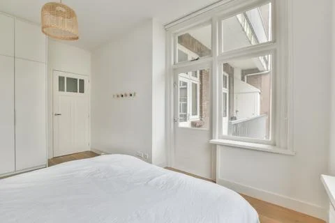 The interior of a bedroom with access to a balcony Stock Photos