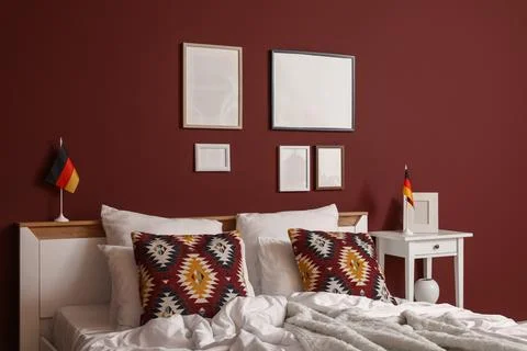 Interior of bedroom with German flags, table and blank frames Stock Photos