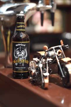 Interior of beer pub, metal model motorcycle at the bar counter Stock Photos