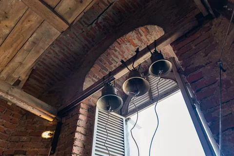 Interior of a bell tower, with three large bells hanging from the ceiling. Th Stock Photos