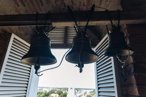 Interior of a bell tower, with three large bells hanging from the ceiling. Th Stock Photos