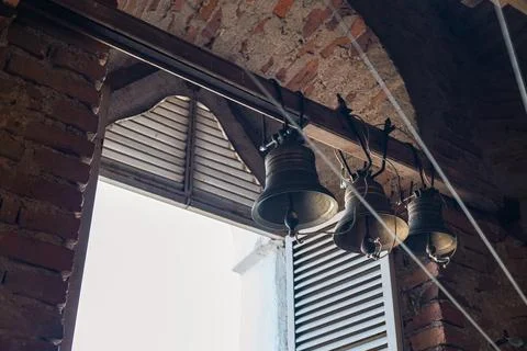 Interior of a bell tower, with three large bells hanging from the ceiling. Th Stock Photos