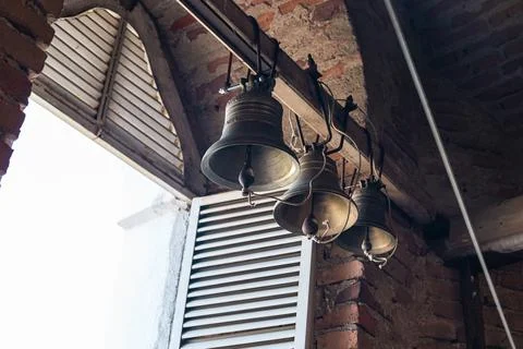 Interior of a bell tower, with three large bells hanging from the ceiling. Th Stock Photos