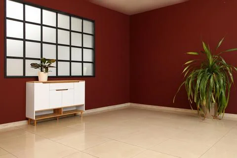 Interior of big empty room with window and houseplants on commode near burgun Stock Photos