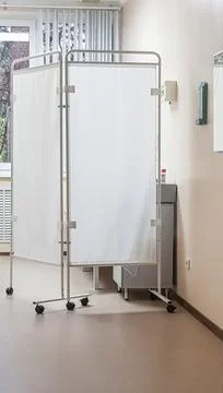 Interior of a bright doctor's office with a folding screen, vertical frame Foto stock