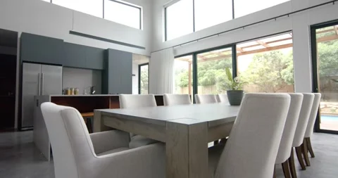 Interior of bright open plan dining room and kitchen with doors to garden, copy Stock Footage 255700151